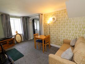 A living room with a sofa and a table at Ty Crigyll in Caergeiliog