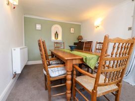 A dining room with a table and chairs at Ty Crigyll in Caergeiliog