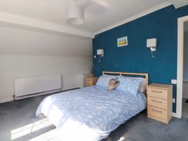 A bedroom with a bed and bedside tables at Ty Crigyll in Caergeiliog