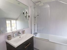 A bathroom with a sink and bathtub at Ty Crigyll in Caergeiliog