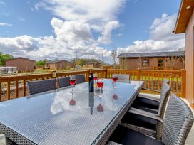 An outdoor seating area with a table and glasses at The Alwalton in Kings Cliffe