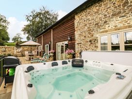 An outdoor area with a hot tub and seating at Lake View in Crediton