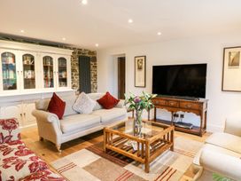 A living room with a sofa and television at Lake View in Crediton