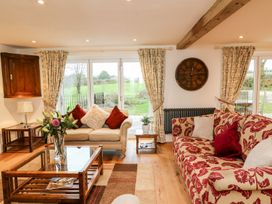 A living room with a sofa and a coffee table at Lake View in Crediton