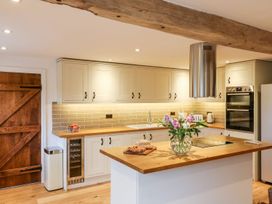 A kitchen with an island and appliances at Lake View in Crediton