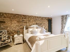 A bedroom with a bed and bedside table at Lake View in Crediton