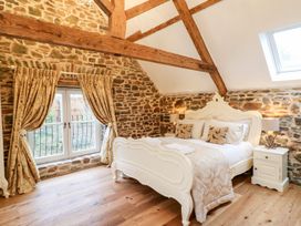 A bedroom with a bed and window at Lake View in Crediton