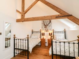A bedroom with two beds and wall art at Lake View in Crediton