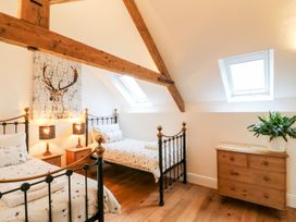 A bedroom with two beds and a dresser at Lake View in Crediton