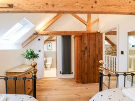 A bedroom with a bed and wardrobe at Lake View in Crediton