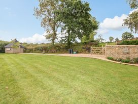 A garden with a shed and lawn at Lake View in Crediton