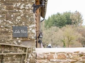 A stone wall with a Lake View sign and lantern at Lake View in Crediton