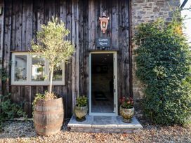 An entrance to a games room with a wooden door at Lake View in Crediton