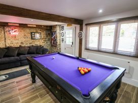 A games room with a pool table and sofa at Lake View in Crediton