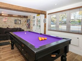 A game room with a pool table and a sofa at Lake View in Crediton