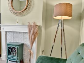 A living room with a lamp and fireplace at Windsor House in York