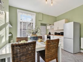 A kitchen with a dining table and chairs at Windsor House in York