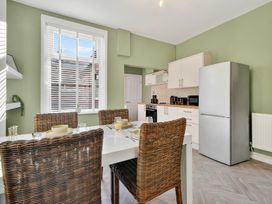 A kitchen with a table and chairs at Windsor House in York