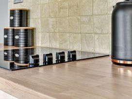 A kitchen with a cooktop and a kettle at Windsor House in York