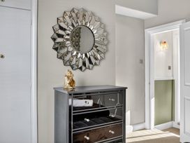 A hallway with a mirror and chest of drawers at Windsor House York