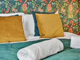 A bedroom with a bed and colorful wallpaper at Windsor House in York