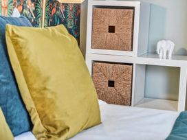 A bedroom with pillows and storage baskets at Windsor House in York