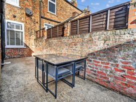 An outdoor seating area with a table and chairs at Windsor House in York
