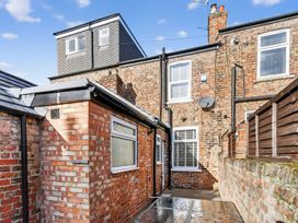 An outdoor area with brick walls and windows at Windsor House in York