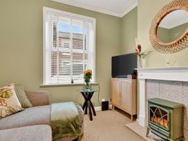 A living room with a couch and television at Windsor House in York
