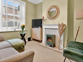 A living room with a television and fireplace at Windsor House in York