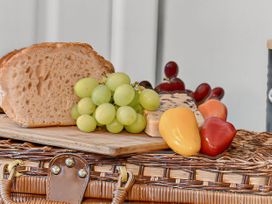 A selection of food including bread, grapes, cheese, and peppers on a wooden board at Windsor House in York