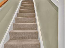 A staircase with carpet and a handrail at Windsor House in York