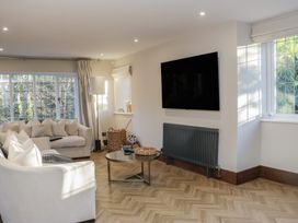 A living room with a sofa and television at North Cottage in Bowness-On-Windermere