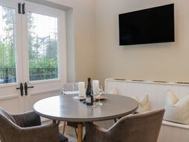 A dining room with a table and chairs at North Cottage Bowness-On-Windermere