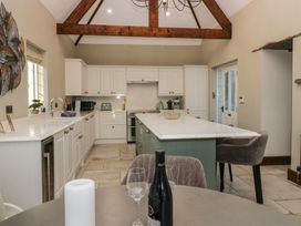 A kitchen with an island and appliances at North Cottage in Bowness-On-Windermere