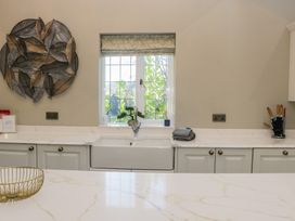 A kitchen with a sink and window at North Cottage in Bowness-On-Windermere