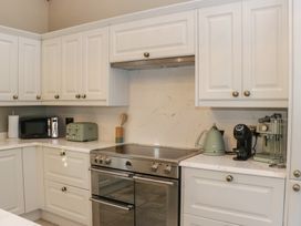 A kitchen with an oven and microwave at North Cottage in Bowness-On-Windermere