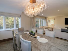 A dining room with a table and chairs at North Cottage in Bowness-On-Windermere