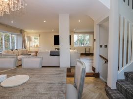 A living room with a chandelier and dining area at North Cottage in Bowness-On-Windermere