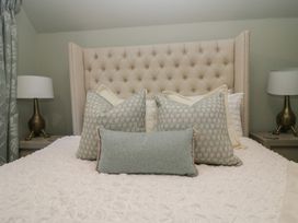 A bedroom with a bed and decorative pillows at North Cottage in Bowness-On-Windermere