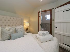 A bedroom with a bed and towels at North Cottage in Bowness-On-Windermere