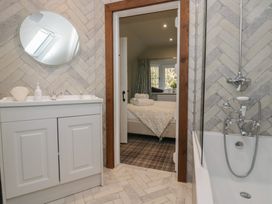 A bathroom with a sink and bathtub at North Cottage in Bowness-On-Windermere