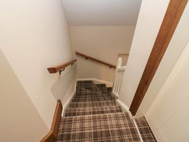 A staircase with a handrail and carpet at North Cottage Bowness-On-Windermere