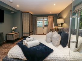 A bedroom with a bed and a dresser at North Cottage Bowness-On-Windermere