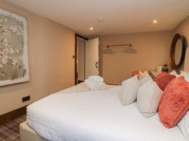 A bedroom with a bed and pillows at North Cottage in Bowness-On-Windermere