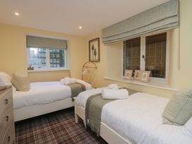 A bedroom with two single beds and a window at North Cottage Bowness-On-Windermere
