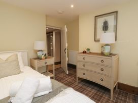 A bedroom with a bed and furniture at North Cottage Bowness-On-Windermere