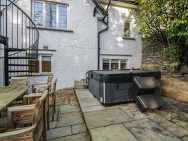 A garden with a hot tub and patio furniture at North Cottage in Bowness-On-Windermere