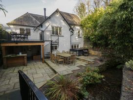 A garden with a patio and furniture at North Cottage in Bowness-On-Windermere