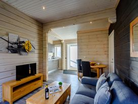 A living room with a television and a dining table at Chestnut Spa Carlton Miniott near Thirsk
